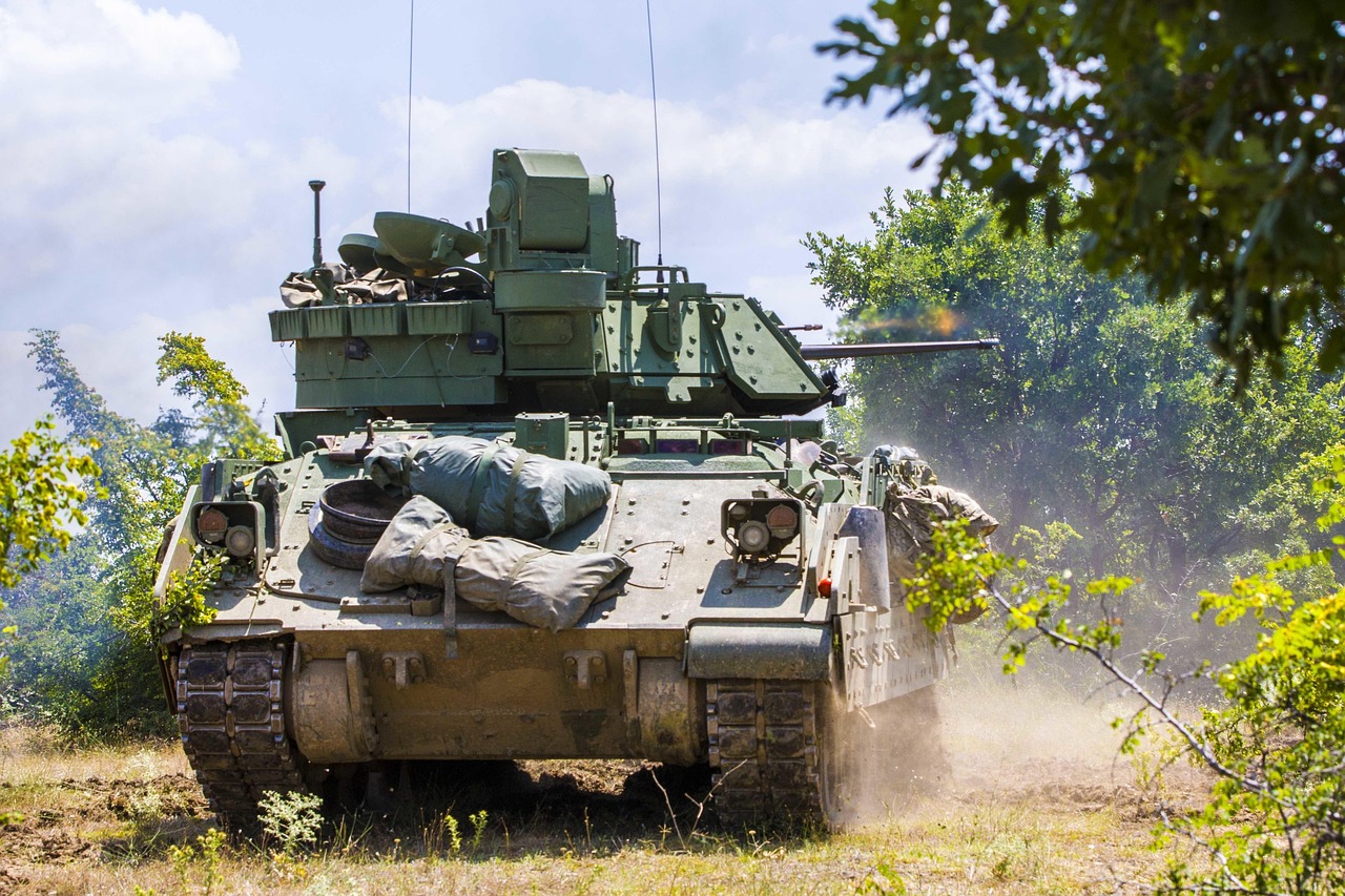 Tracked armored fighting vehicle driving across a training range